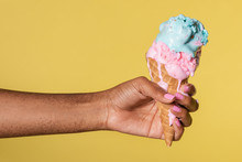 Hand Holding A Melting Ice Cream