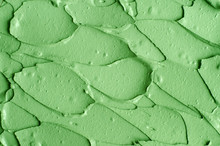 Green Cosmetic Clay (cucumber Facial Mask, Avocado Face Cream, Green Tea Matcha Body Wrap) Texture Close Up, Selective Focus. Abstract Background With Brush Strokes.