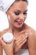 © didesign - Laughing girl with flawless skin applying moisturizer cream on her shoulder