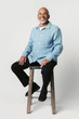 © rawpixel.com - Happy retired man sitting on a stool