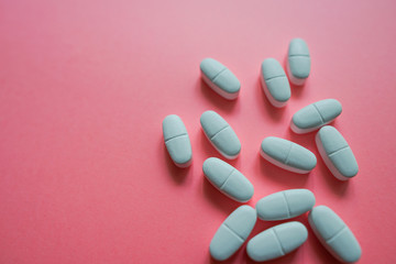 Wall Mural - White pills  on a colorful background with a free area for text