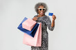 © rawpixel.com - Cheerful senior woman on a shopping spree with a credit card