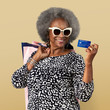 © rawpixel.com - Cheerful black senior woman with shopping bags and a credit card mockup