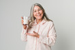 © rawpixel.com - Cheerful senior woman drinking a glass of milk