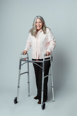 Poster - Happy senior woman using a zimmer frame