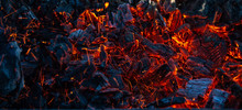 Burning Coals In The Dark, Smoldering Coal. Bright Red Sparks Of Fire. Background.