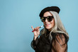 © rawpixel.com - Cool grandma with a vape on blue background