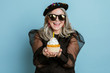 © rawpixel.com - Cool grandma celebrating her birthday with a cupcake