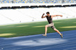 © LIGHTFIELD STUDIOS - fast handsome runner exercising on running track at stadium