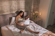 © Impact Photography - Pregnant woman reading in bed in the morning