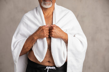 Wall Mural - Senior African American man with a white bath towel