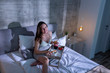 © Impact Photography - Pregnant woman eating in bed at night