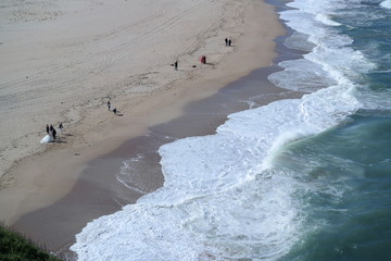 Wall Mural - waves on the beach and wedding photo shoot