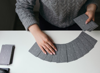 woman hands with tarot cards on the table