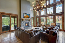 Amazing Two Story Tall Living Room Interior  With Sky Bridge And Leather Furniture.