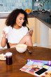© LIGHTFIELD STUDIOS - happy african american woman using smartphone near tasty breakfast