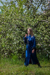 a woman practices qigong in a wild Apple garden