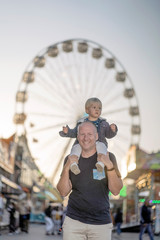 Wall Mural - Happy father with his little son in an amusement park