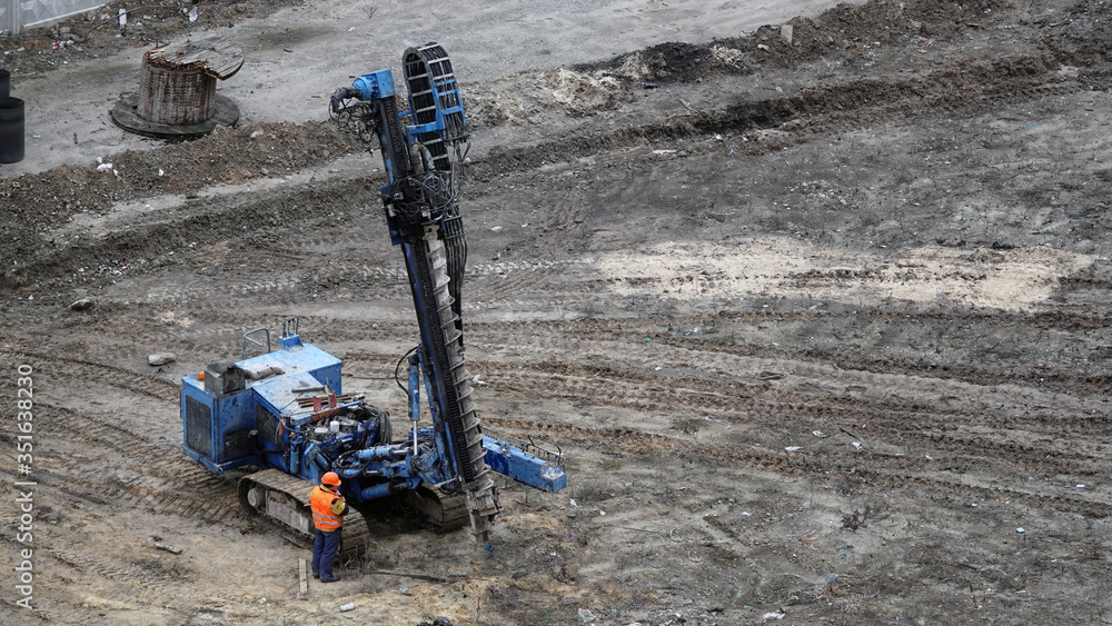 Oil Rig Bore Drilling rig boring the ground pours a hole in the concrete for the ...