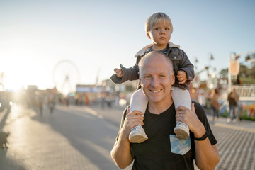 Wall Mural - Happy father with his little son in an amusement park