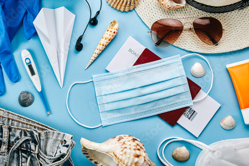 Fotomural Overhead view of coronavirus travel accessories on blue background