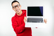 © Ivan Traimak - smiling attractive brunette man demonstrates a blank laptop screen with mockup in his hands on a white studio background
