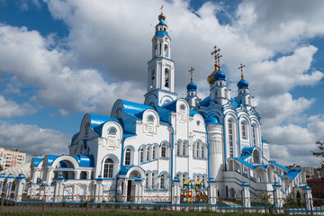 Main facade of St. Alexander Nevsky church, lighted by summer sunlight, Kazan, Russia. Church built in traditional Russian orthodox style, with white walls, tall bell tower, & blue & gold domes