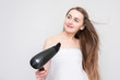 © Анастасия Семашко - Pretty woman with hair dryer, portrait, white background. Hair care, copy space
