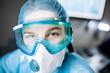 © velimir - young woman surgeon doctor in uniform and goggles in the operating room during a pandemic.