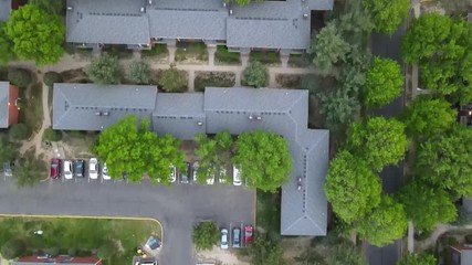 Wall Mural - Overhead aerial view of the suburban area apartment district with cars parking lot stay home concept of self isolation during in the Covid-19 coronavirus pandemic.