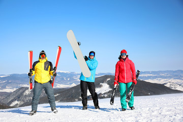 Wall Mural - Friends with equipment at ski resort. Winter vacation