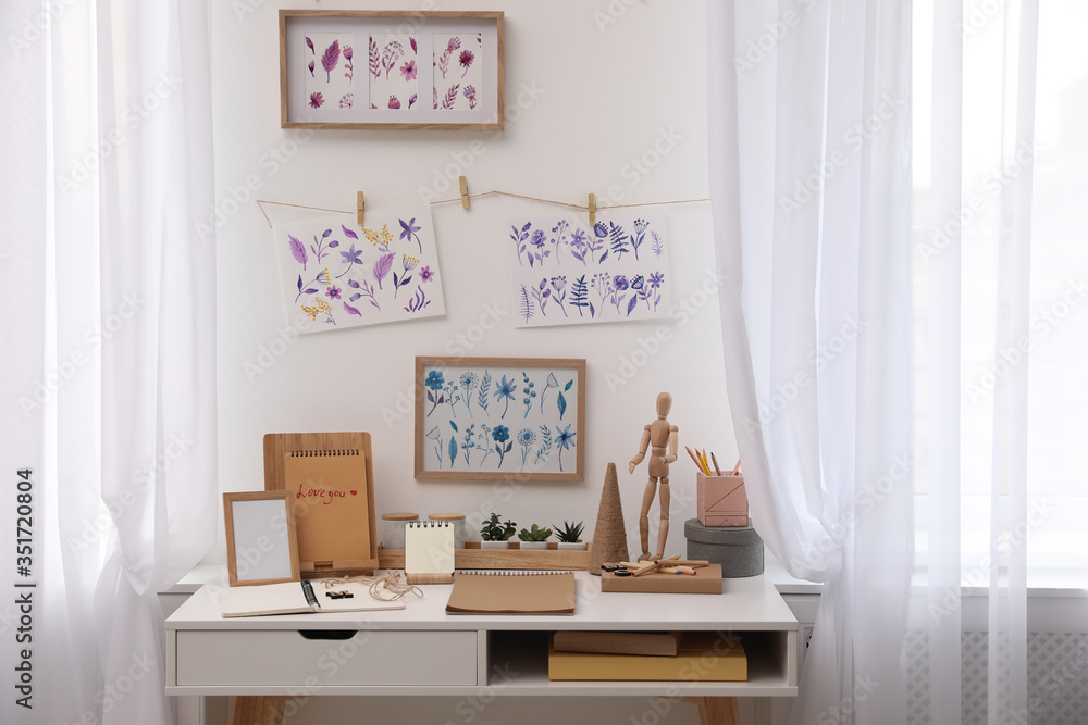 Stylish room interior with creative workplace near white wall - obrazy, fototapety, plakaty 