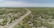 Wide Rising Shot Of Dotted Bush Biome With Main Road