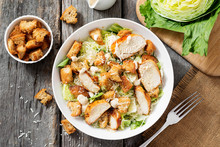Classic Caesar Salad With Grilled Chicken Fillet And Parmesan Cheese. Top View