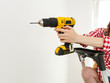 © Voyagerix - Hand holding yellow drill