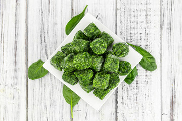 Wall Mural - Frozen spinach cubes (close up; selective focus)