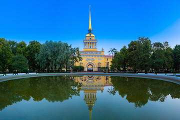 Saint Petersburg. Russia. The Admiralty building is reflected in the water. Admiralty on the background of water in the fountain. A Golden spire with a ship against the blue sky. Summer in Petersburg.