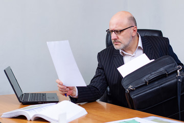 Wall Mural - A businessman works with documents. The man found the necessary