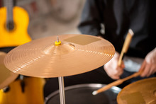 Round Golden Color Cymbal As Part Of Drum Set On Background Of Drummer