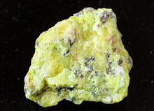 Closeup Of Sample Of Natural Mineral From Geological Collection - Rough Native Sulphur (Sulfur) Rock On Black Granite Background From Vodinskoye Deposit, Samara Region, Russia