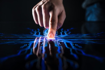 digitalization concept: human finger pushes touch screen button and activates futuristic artificial 