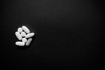 Wall Mural - White pills  on a paper background with a free area for text