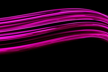 Wall Mural - Long exposure photograph of neon pink colour in an abstract swirl, parallel lines pattern against a black background. Light painting photography.
