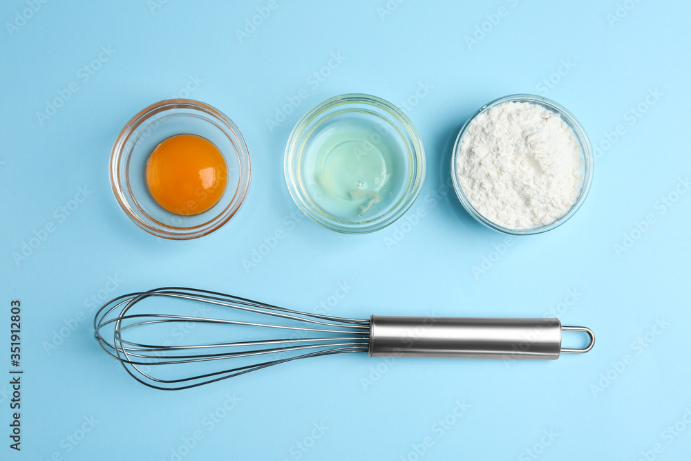 Flat lay composition with chicken egg and flour on light blue background - obrazy, fototapety, plakaty 