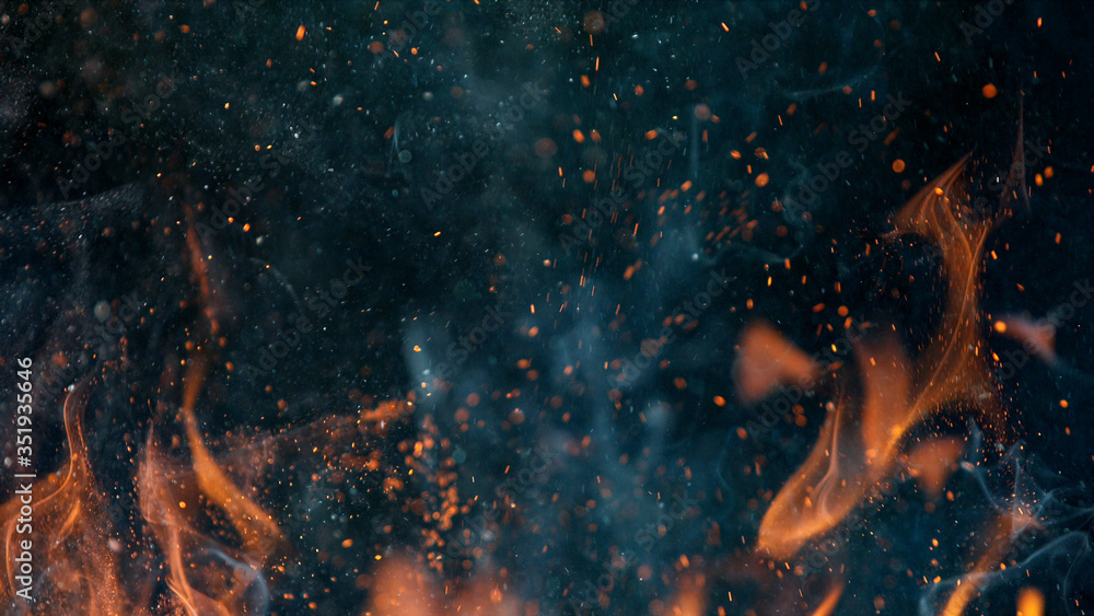 fire flames with sparks on a black background, close-up - obrazy, fototapety, plakaty 