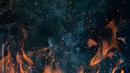 Fotografía fire flames with sparks on a black background, close-up