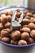 © Alex Puhovoy - Walnuts in a nutshell. Many of whole walnuts and walnut cracker. Selective soft focus.