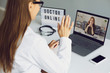 © Studio Romantic - Doctor online. A young woman has an online video consultation with a doctor at the clinic office.