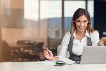 Modern business woman in the office working at computer