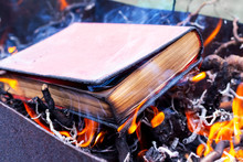 A Thick Book On Fire. Burning Books. Destruction Of Banned Books